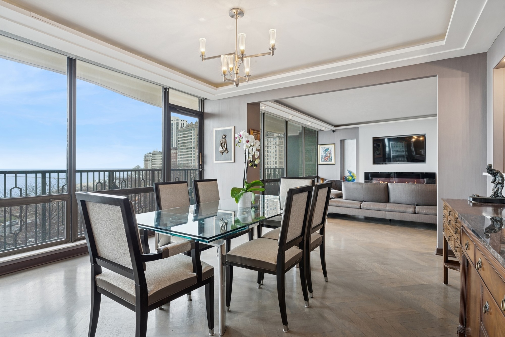 1040 North Lake Shore Drive, Unit 7C Chicago, IL 60611 - Photo 11 of 37 a dining room with furniture a chandelier and wooden floor