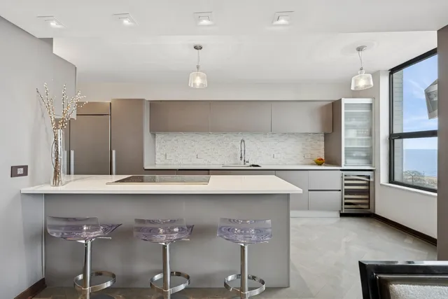 a kitchen with stainless steel appliances a sink and cabinets