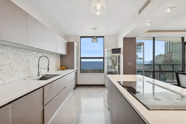 a large white kitchen with a large window