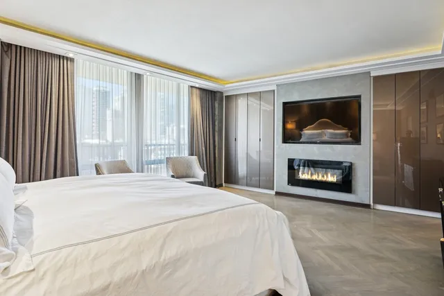 a bedroom with a bed and a fireplace