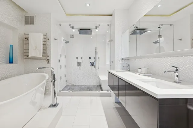 a bathroom with a tub sink and mirror