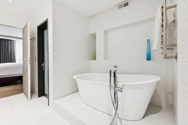 a bath tub sitting in a bathroom next to a sink