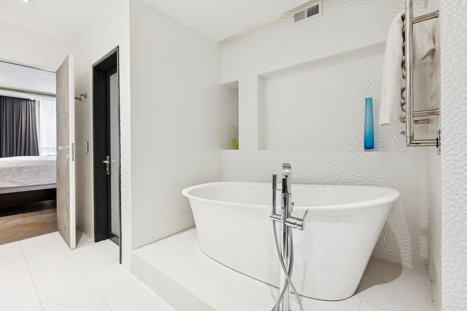 1040 North Lake Shore Drive, Unit 7C Chicago, IL 60611 - Photo 19 of 37 a bath tub sitting in a bathroom next to a sink
