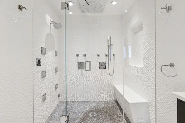 a bathroom with a glass shower door
