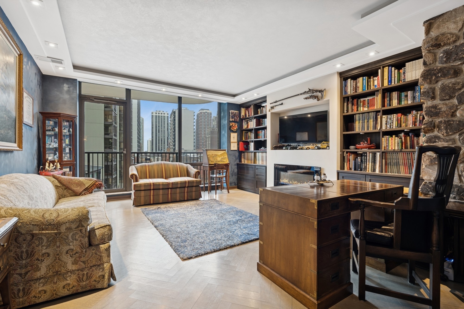 1040 North Lake Shore Drive, Unit 7C Chicago, IL 60611 - Photo 21 of 37 a living room with furniture and a flat screen tv
