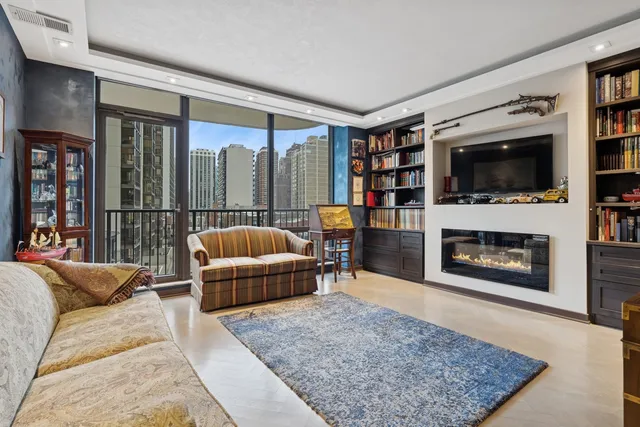 a living room with furniture a flat screen tv and a fireplace