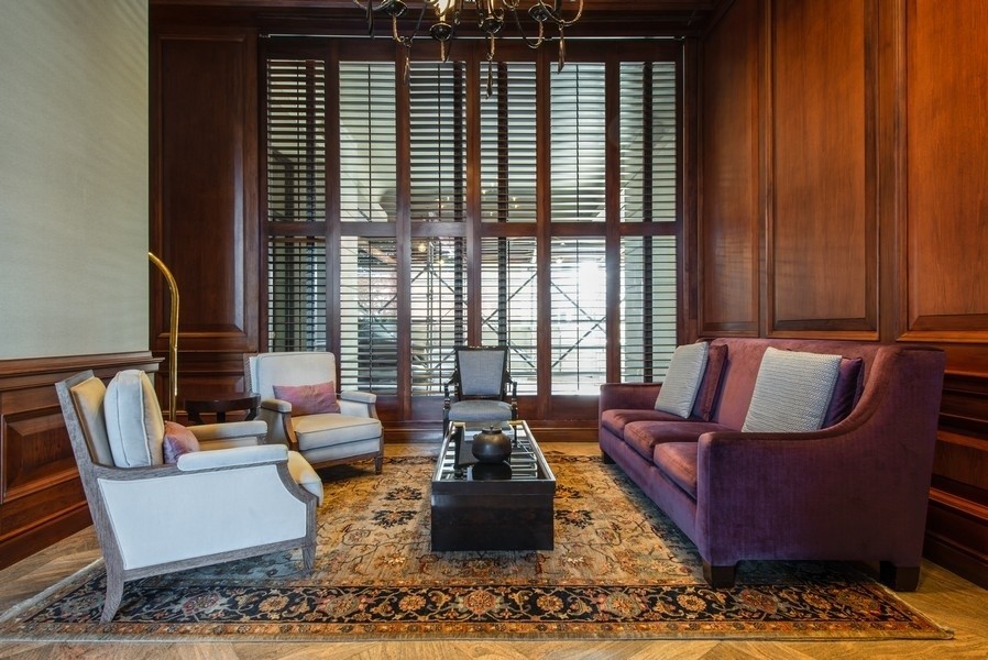 1040 North Lake Shore Drive, Unit 7C Chicago, IL 60611 - Photo 36 of 37 a living room with furniture and floor to ceiling windows