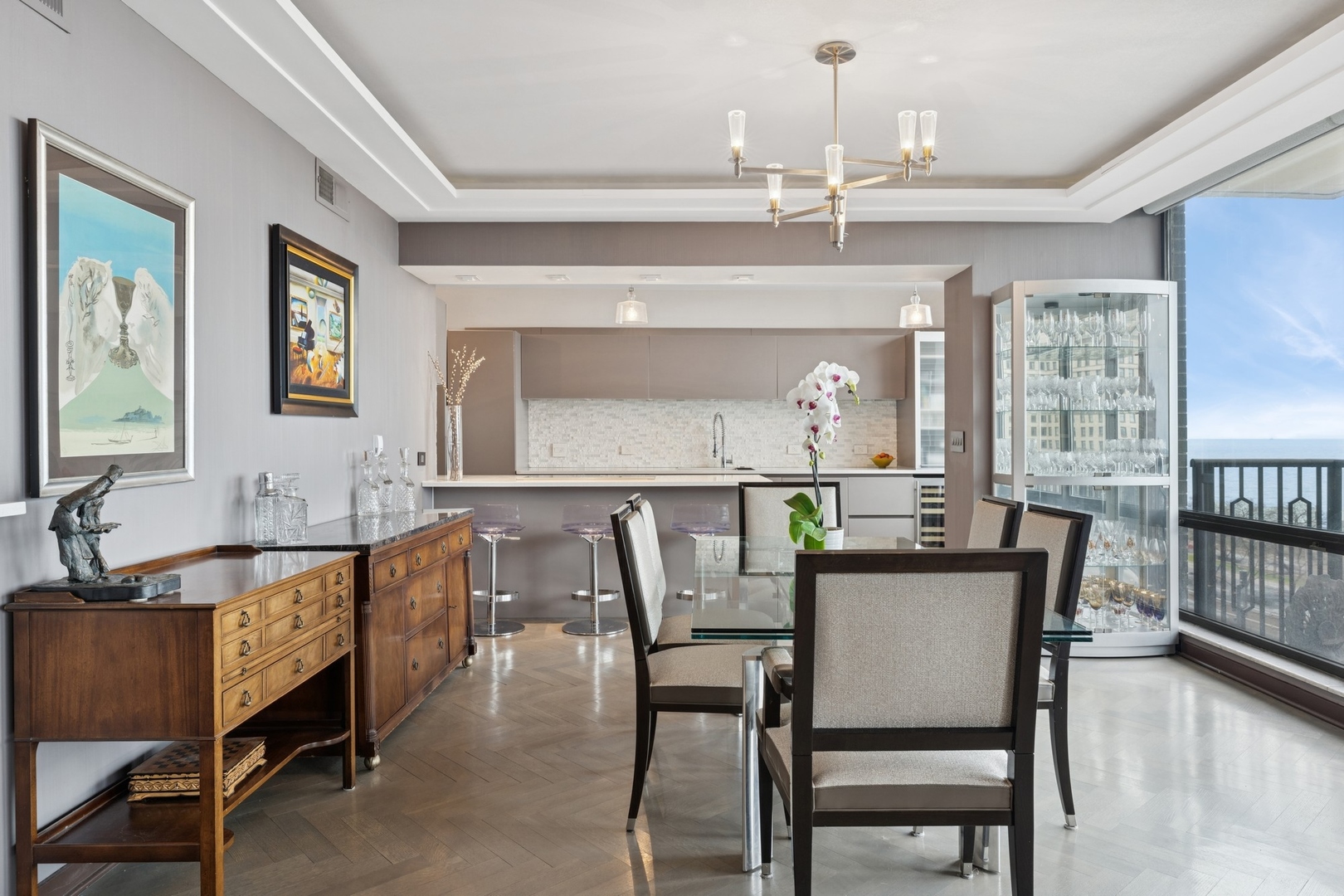 1040 North Lake Shore Drive, Unit 7C Chicago, IL 60611 - Photo 9 of 37 a dining room with furniture a chandelier and wooden floor