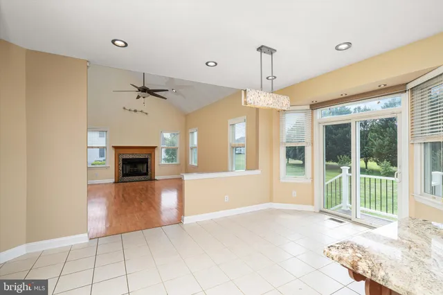 a view of an empty room with a fireplace and a window