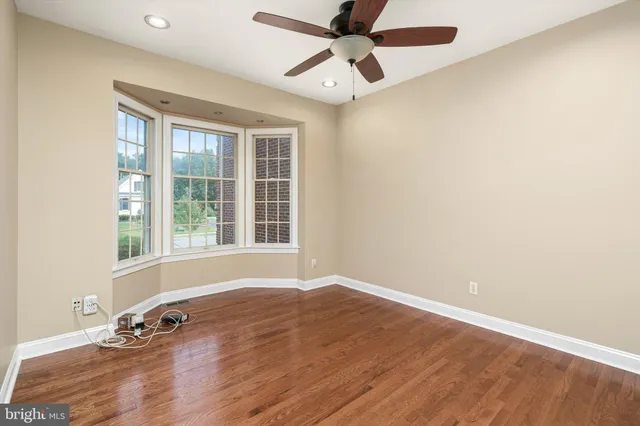 a view of a room with wooden floor and windows