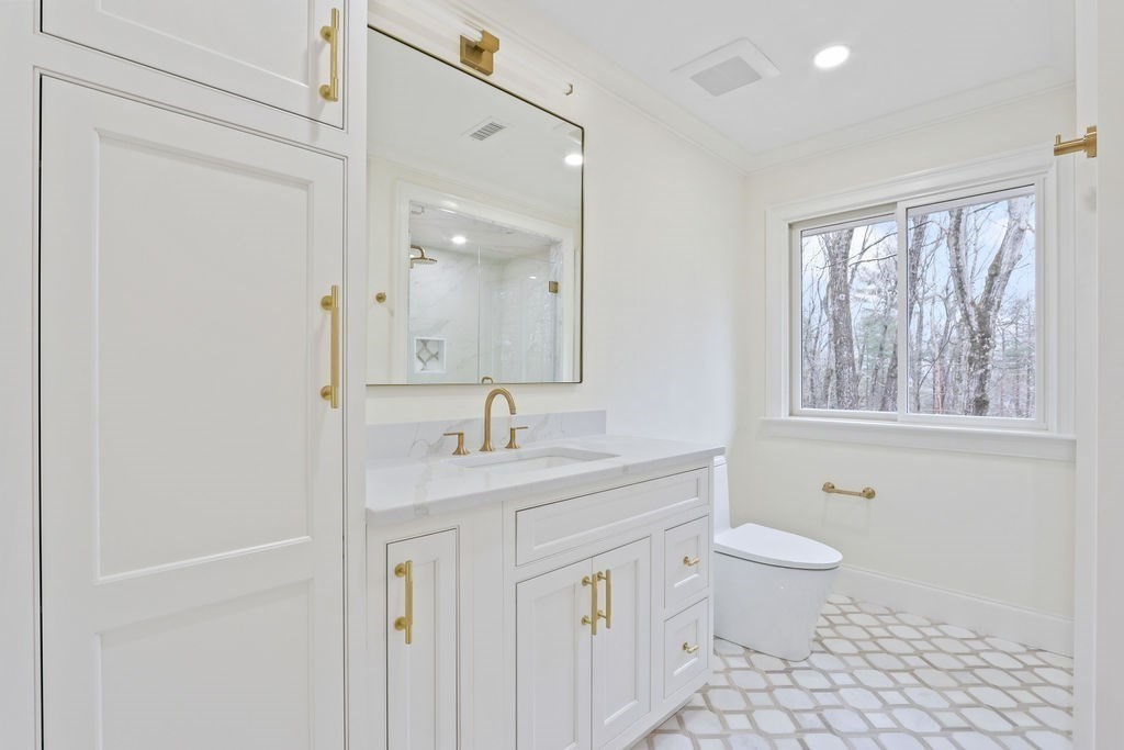 80 Doublet Hill Road Weston, MA 02493 - Photo 29 of 38 a bathroom with a granite countertop sink a toilet and a mirror
