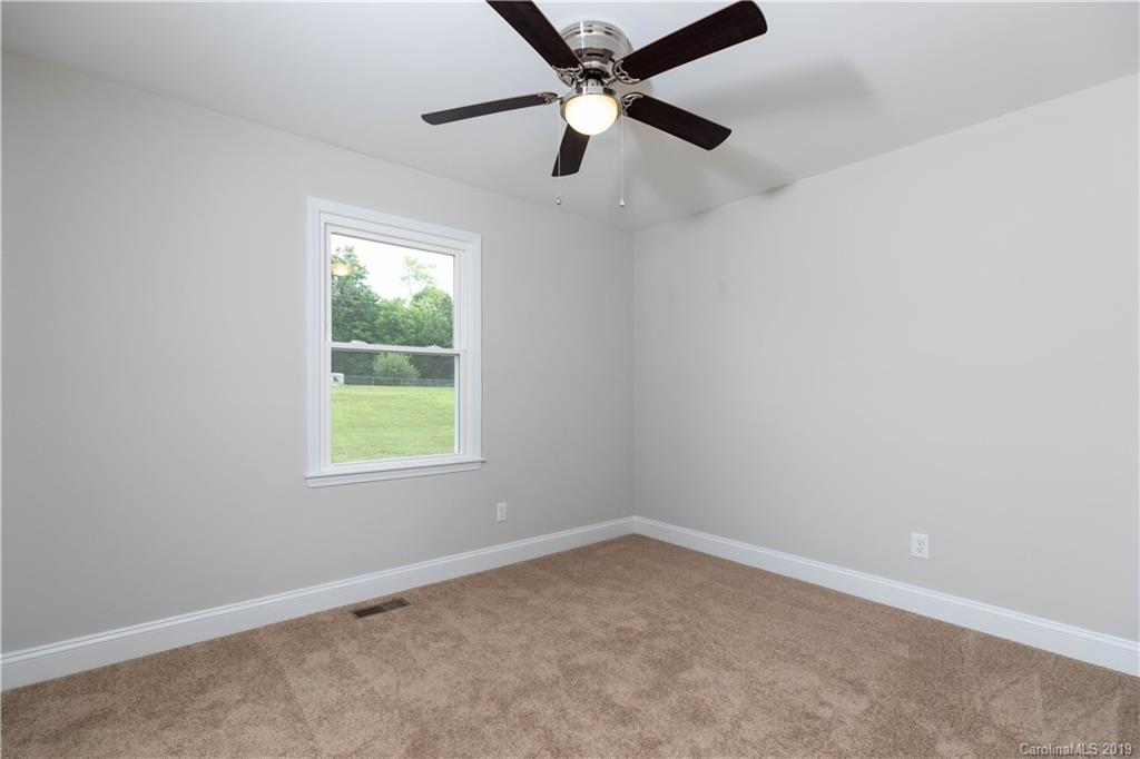 3725 Jenkins Road Blacksburg, SC 29702 - Photo 14 of 21 an empty room with a window and a fan