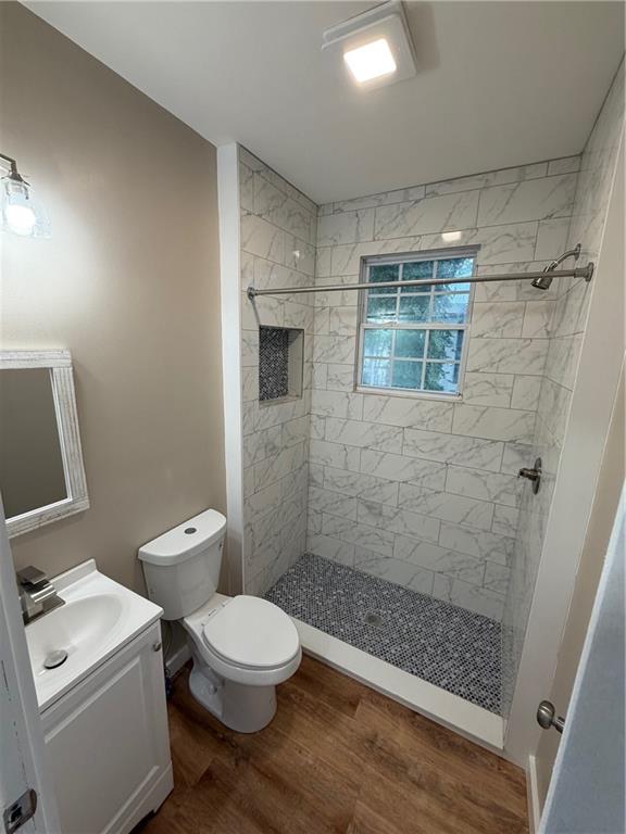 696 Goodyear Avenue Rockmart, GA 30153 - Photo 7 of 9 a white toilet sitting next to a bathroom sink