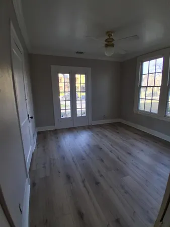 wooden floor in an empty room with a window