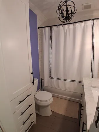 a bathroom with a toilet a sink and shower