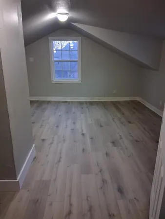 a view of a backyard with wooden fence