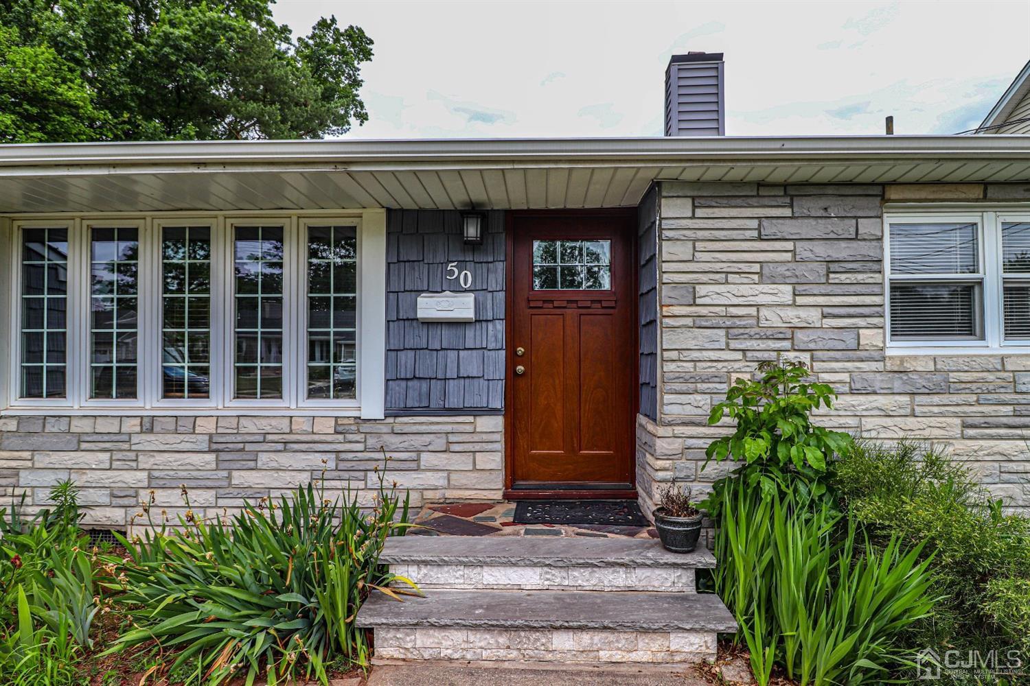 50 Albemarle Road Colonia, NJ 07067 - Photo 2 of 22 a front view of a house with a garden