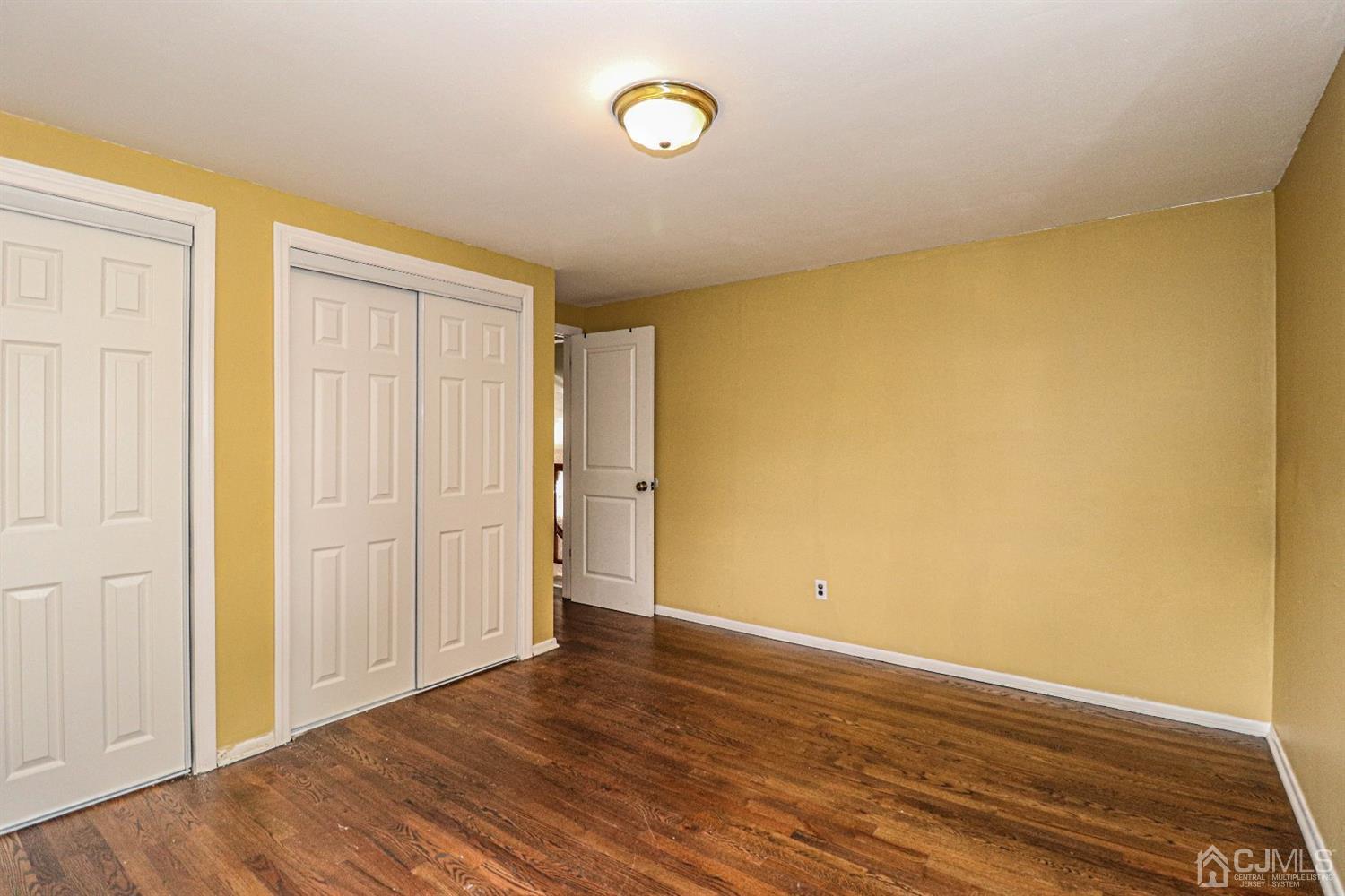 50 Albemarle Road Colonia, NJ 07067 - Photo 11 of 22 a view of an empty room with wooden floor and a window