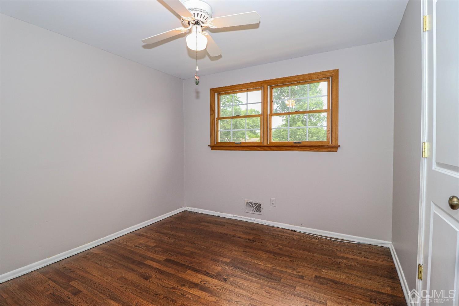 50 Albemarle Road Colonia, NJ 07067 - Photo 12 of 22 wooden floor in an empty room with a window