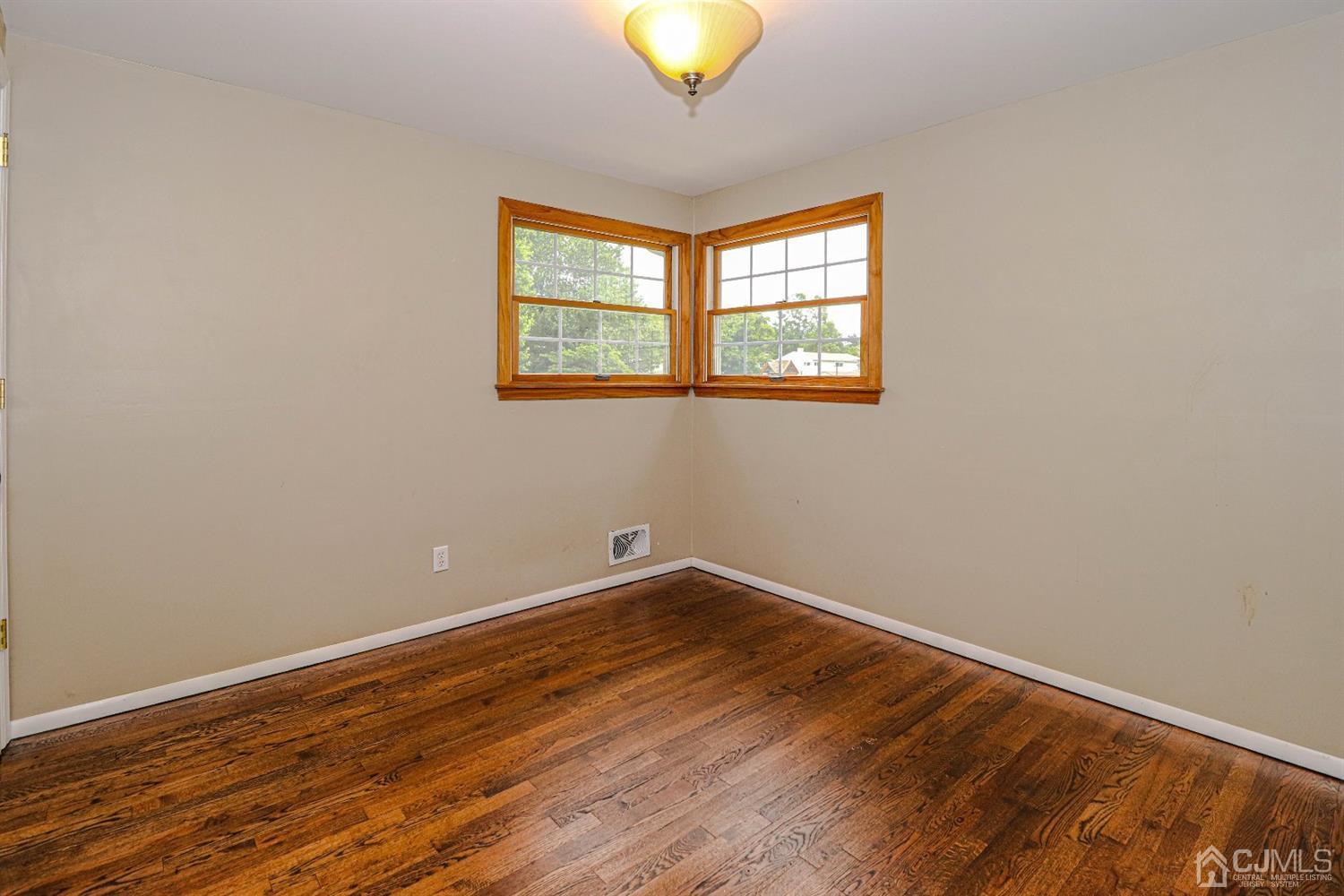 50 Albemarle Road Colonia, NJ 07067 - Photo 13 of 22 wooden floor in an empty room with a window