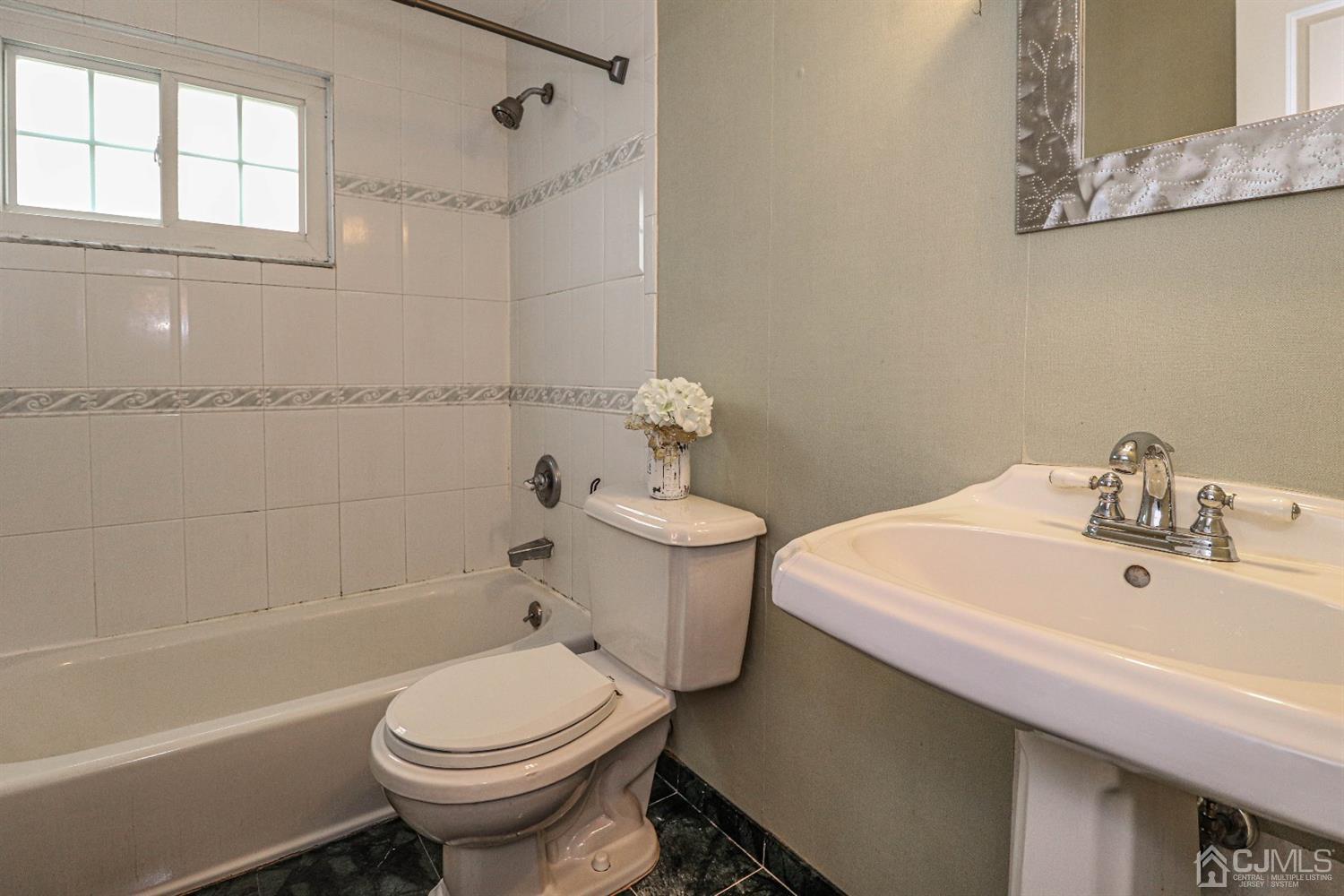 50 Albemarle Road Colonia, NJ 07067 - Photo 17 of 22 a bathroom with a sink a toilet and shower