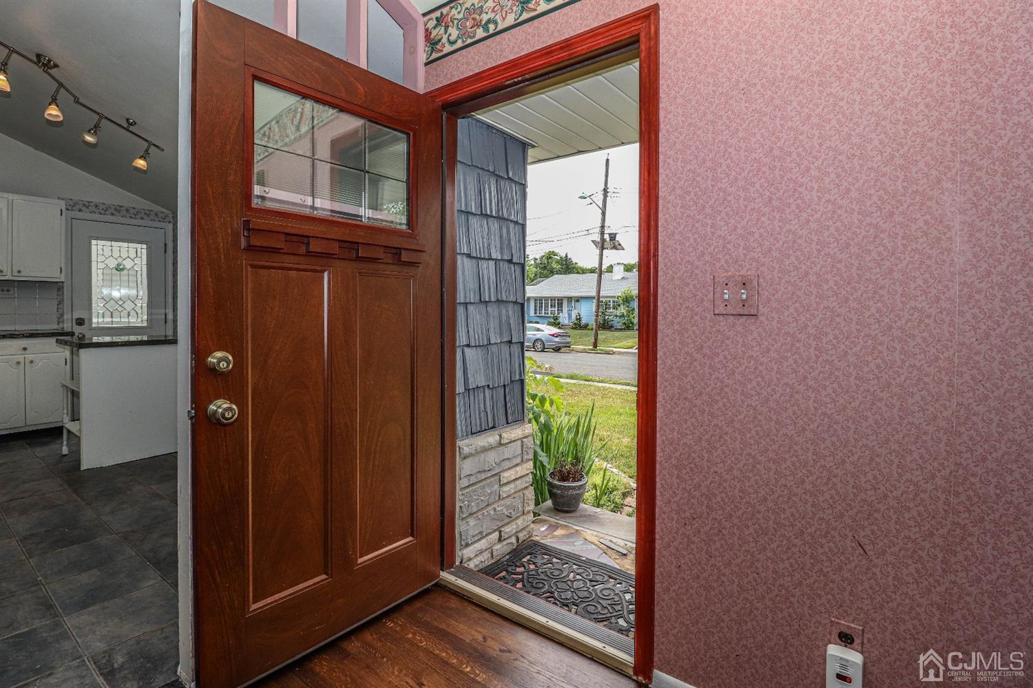 50 Albemarle Road Colonia, NJ 07067 - Photo 3 of 22 a view of a hallway with wooden floor and a bathroom