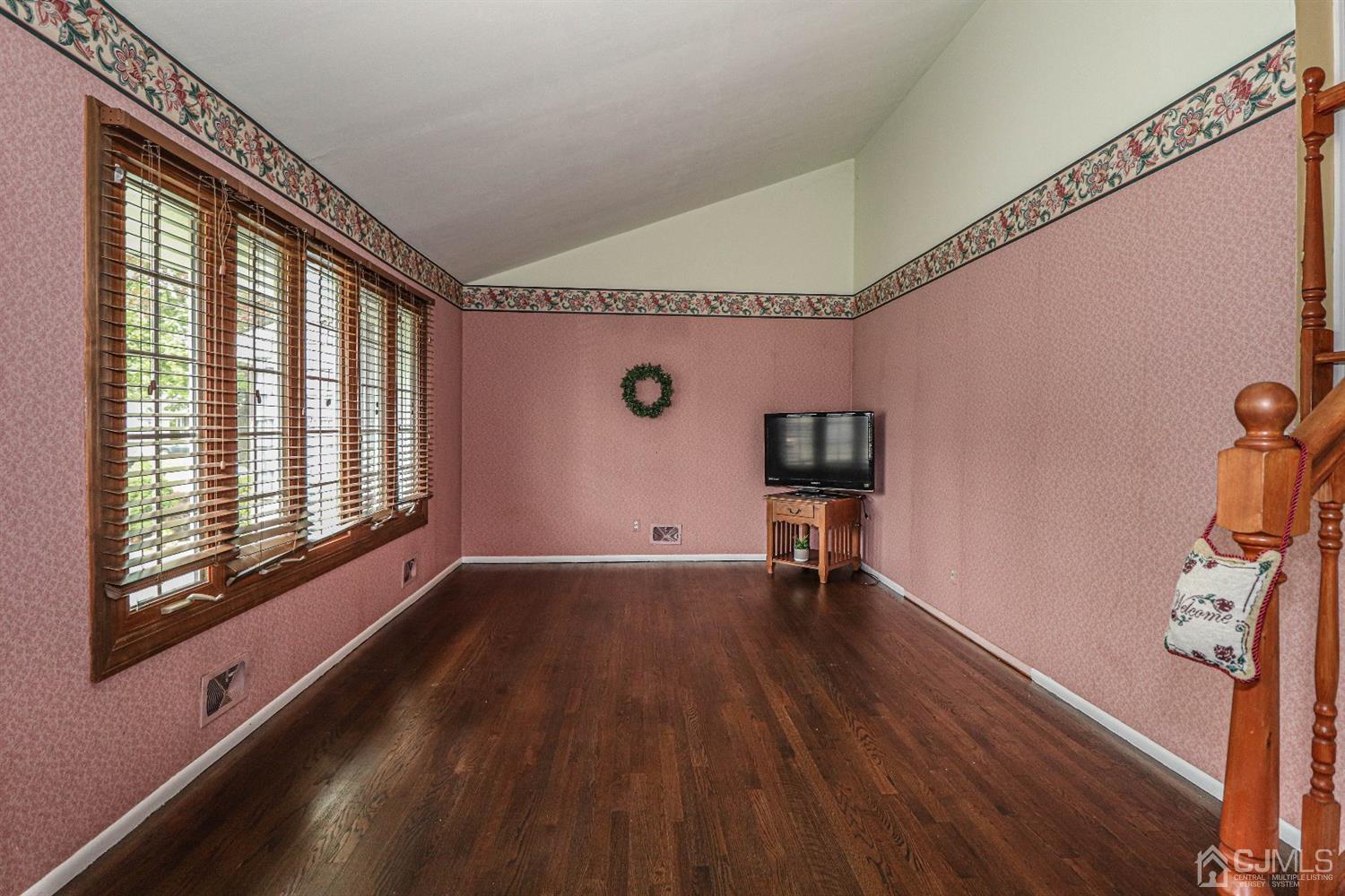 50 Albemarle Road Colonia, NJ 07067 - Photo 4 of 22 a view of an empty room with wooden floor and a window