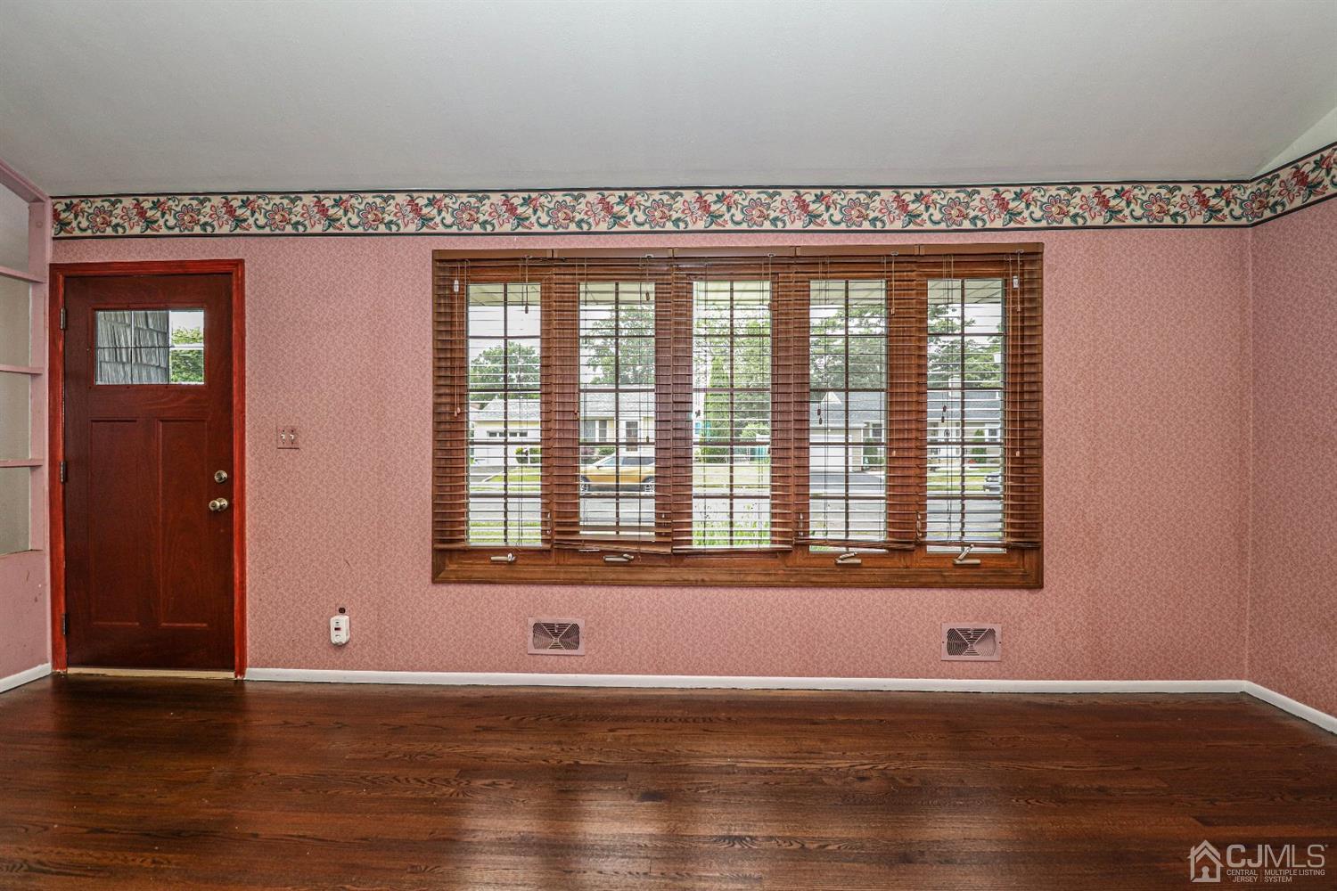 50 Albemarle Road Colonia, NJ 07067 - Photo 5 of 22 an empty room with wooden floor and windows