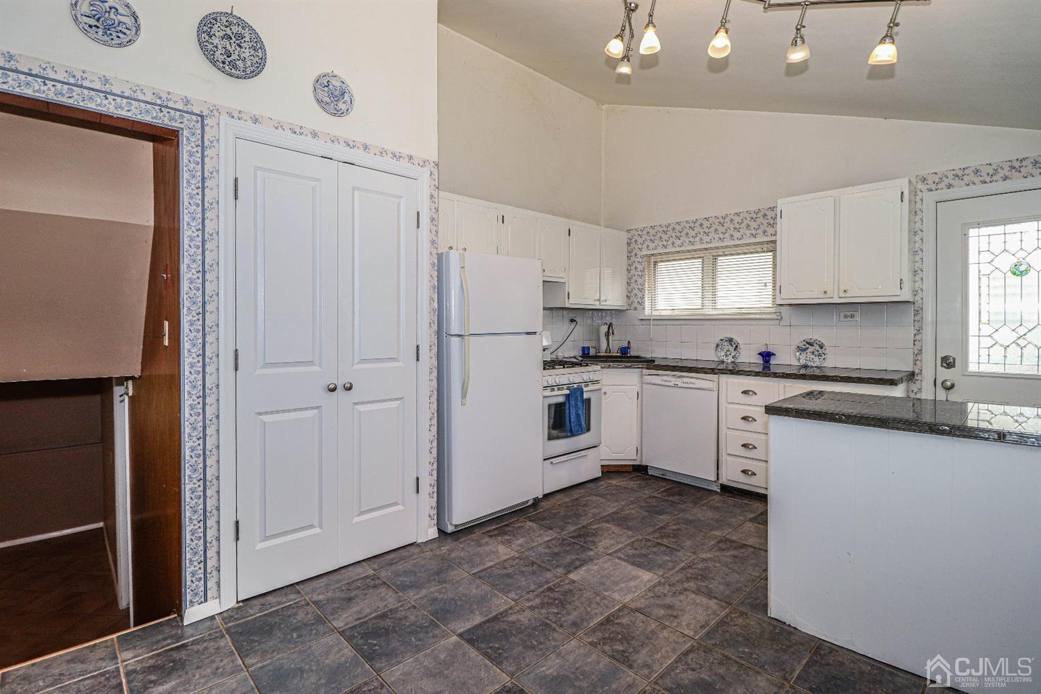 50 Albemarle Road Colonia, NJ 07067 - Photo 6 of 22 a kitchen with white cabinets and white appliances