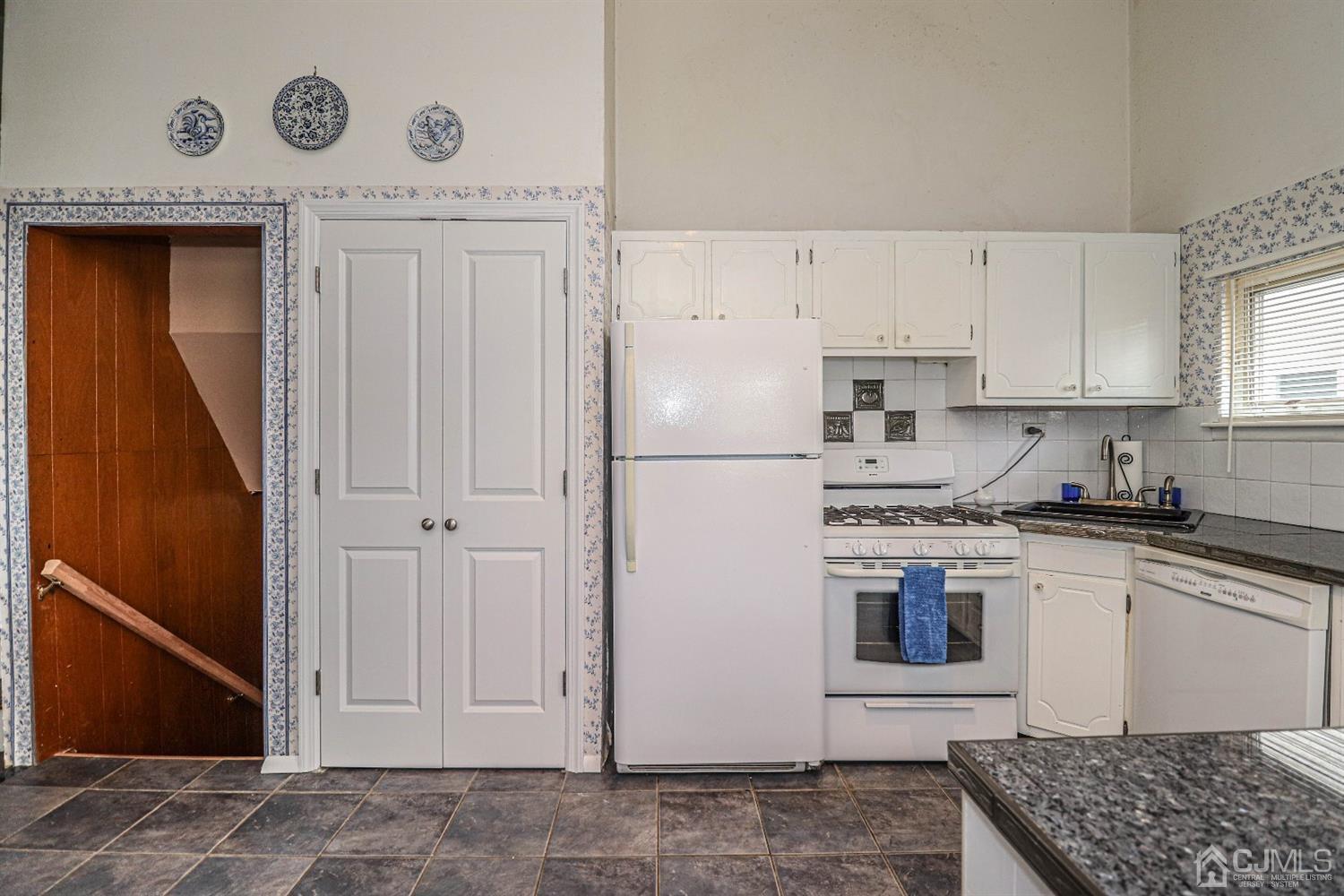 50 Albemarle Road Colonia, NJ 07067 - Photo 7 of 22 a kitchen with a stove a refrigerator and cabinets