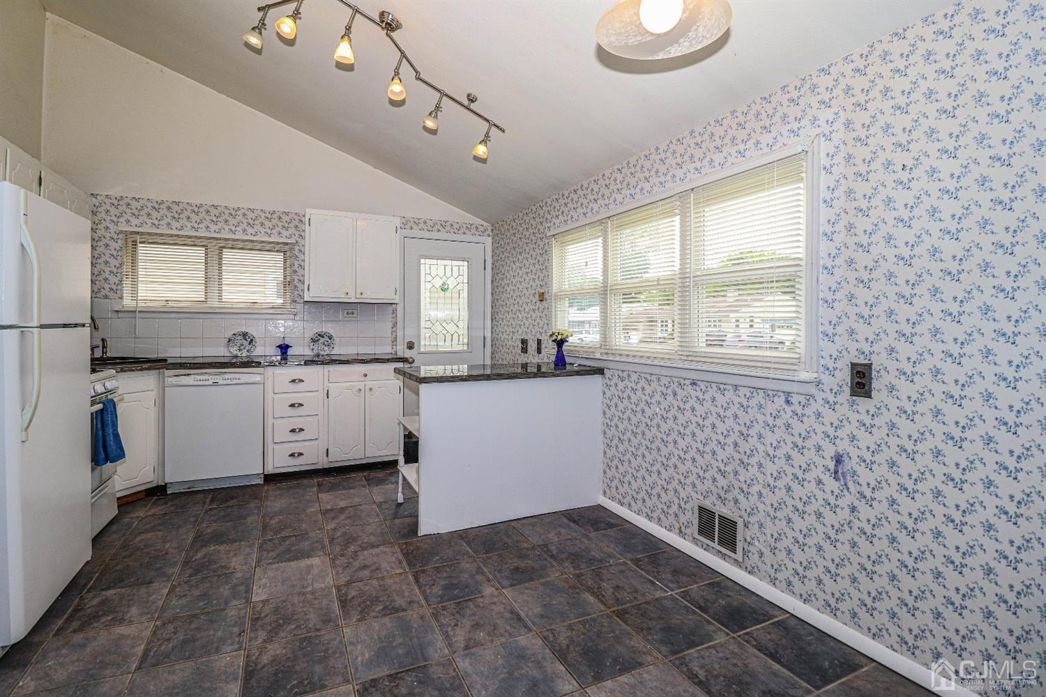 50 Albemarle Road Colonia, NJ 07067 - Photo 9 of 22 a kitchen with a sink a window and cabinets