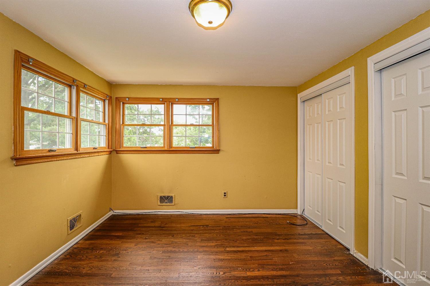 50 Albemarle Road Colonia, NJ 07067 - Photo 10 of 22 a view of an empty room with wooden floor and a window