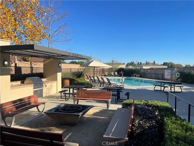 a view of a patio with swimming pool table and chairs