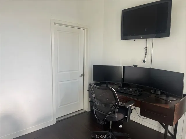 a view of workspace with wooden floor windows