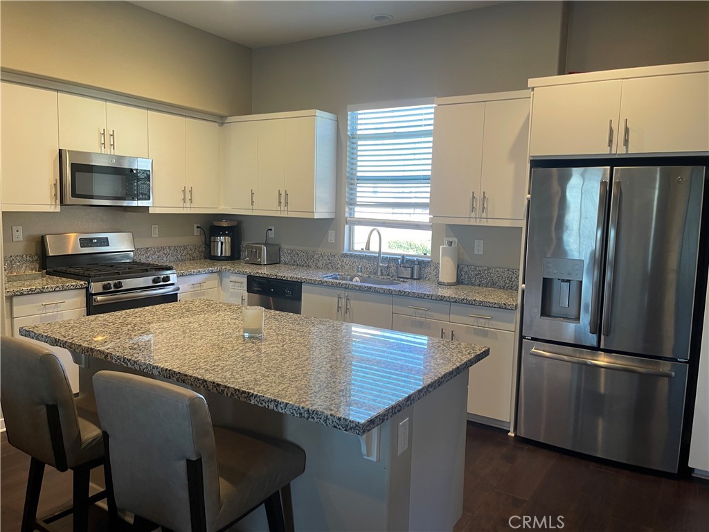 768 Central Upland, CA 91786 - Photo 6 of 15 a kitchen with stainless steel appliances granite countertop a sink refrigerator stove microwave and cabinets