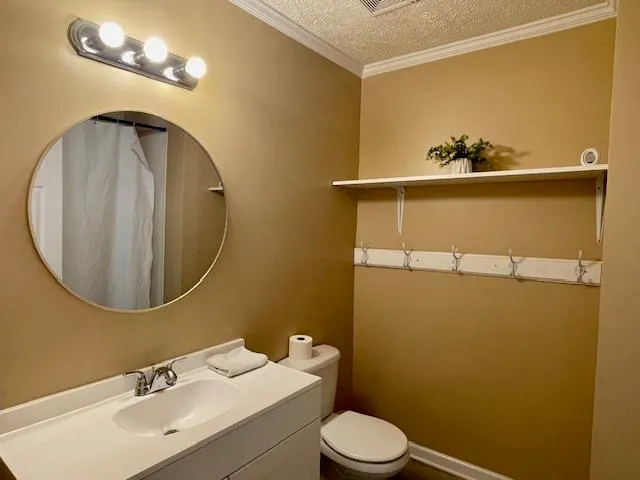 a bathroom with a sink mirror and toilet