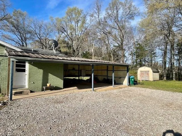 a view of a house with a outdoor space and car parked