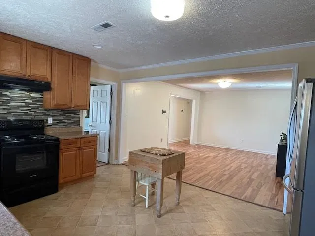 a kitchen with granite countertop cabinets and stainless steel appliances