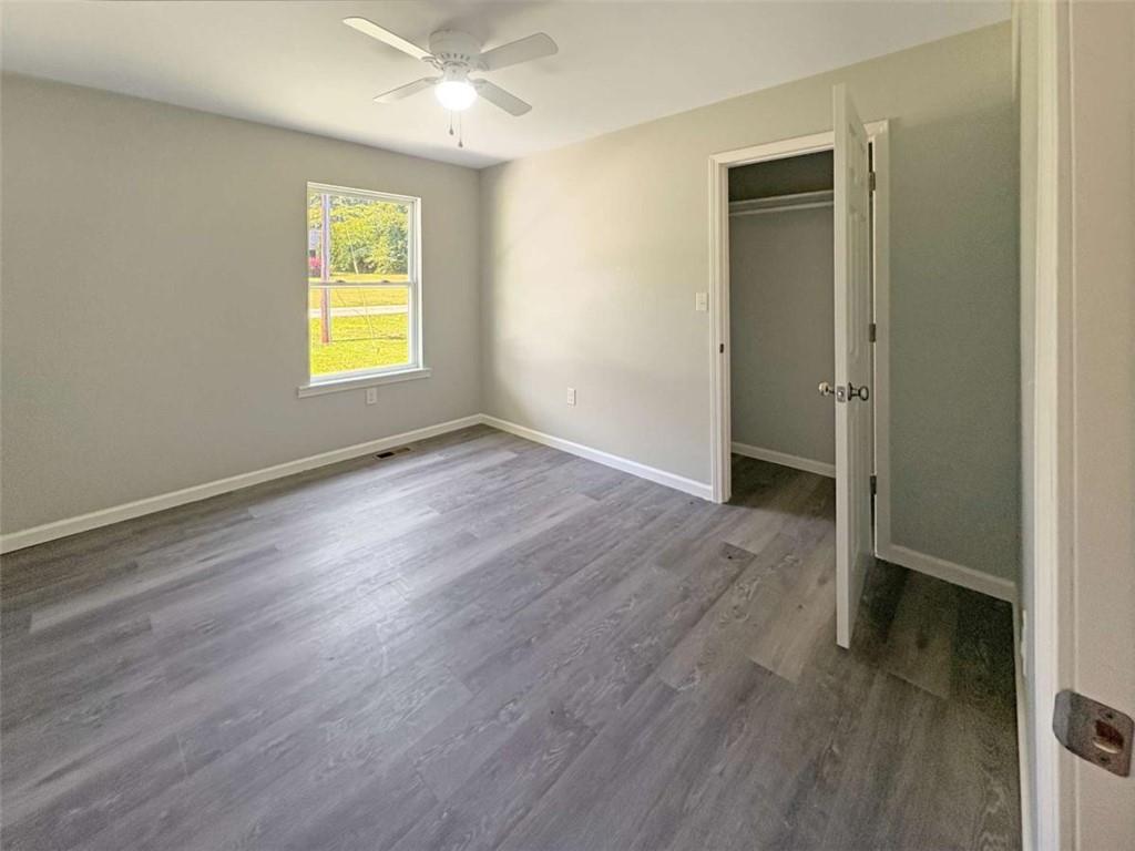 24 George Street Forsyth, GA 31029 - Photo 9 of 17 an empty room with wooden floor and a window