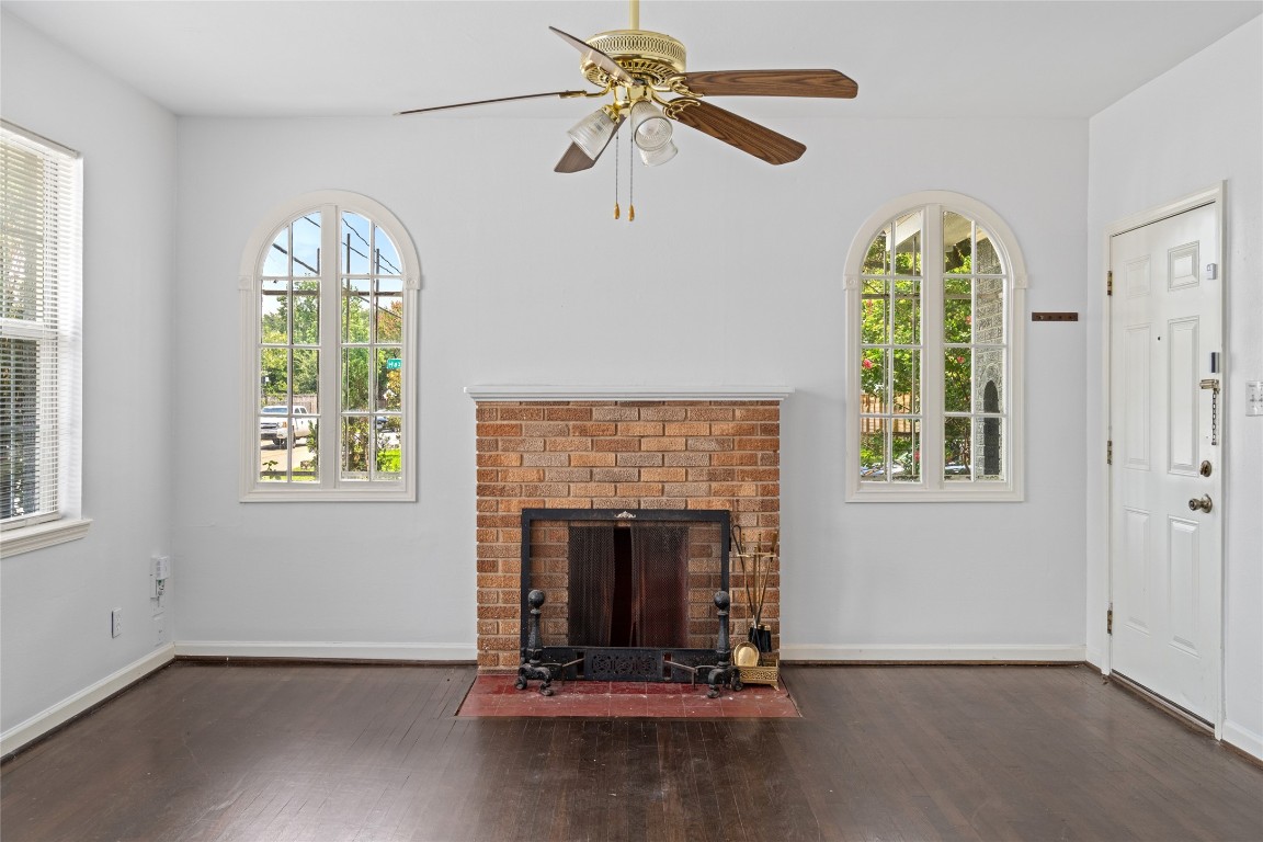 2402 Hazard Street Houston, TX 77019 - Photo 11 of 41 a living room with a fireplace windows and a chandelier