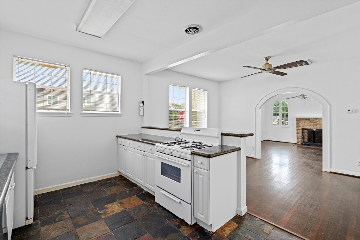 2402 Hazard Street Houston, TX 77019 - Photo 16 of 41 a kitchen with a stove and a chandelier