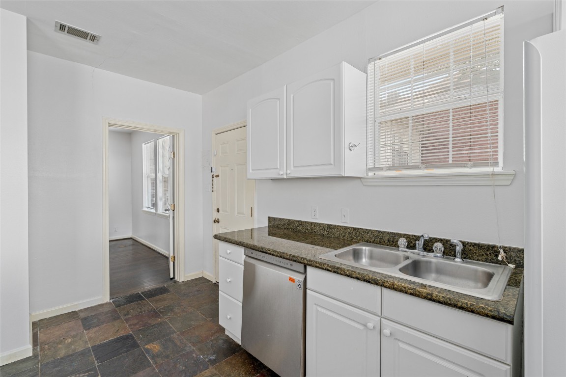 2402 Hazard Street Houston, TX 77019 - Photo 17 of 41 a kitchen with granite countertop white cabinets and sink