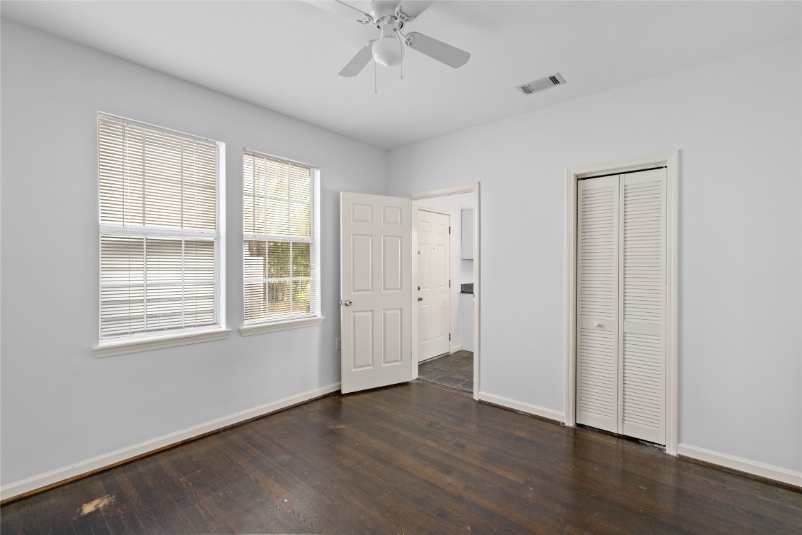 2402 Hazard Street Houston, TX 77019 - Photo 19 of 41 an empty room with wooden floor closet and windows