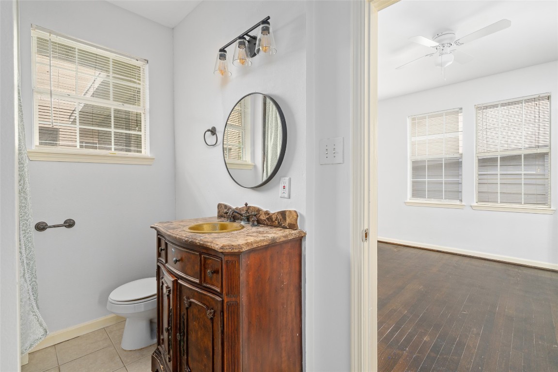 2402 Hazard Street Houston, TX 77019 - Photo 21 of 41 a bathroom with a toilet a sink and a mirror