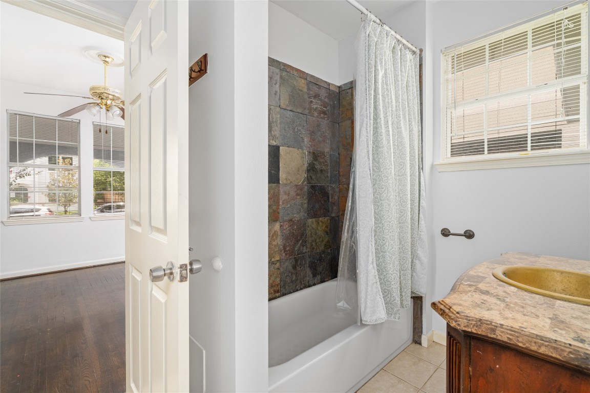 2402 Hazard Street Houston, TX 77019 - Photo 22 of 41 a bathroom with a granite countertop sink and mirror with bathtub