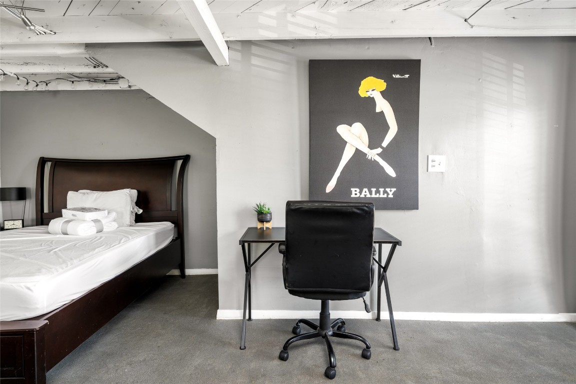 2402 Hazard Street Houston, TX 77019 - Photo 27 of 41 a bedroom with a bed and a chandelier