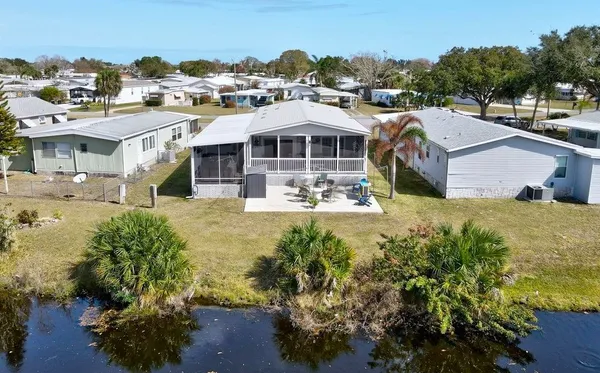 a aerial view of a house with a yard swimming pool and outdoor seating