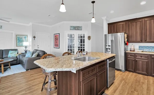 a kitchen with granite countertop a sink stove and refrigerator
