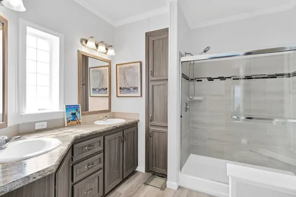 a bathroom with a granite countertop sink mirror and a bathtub