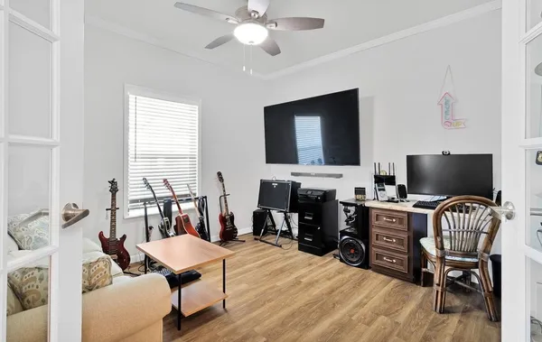 a view of a livingroom with workspace and a window